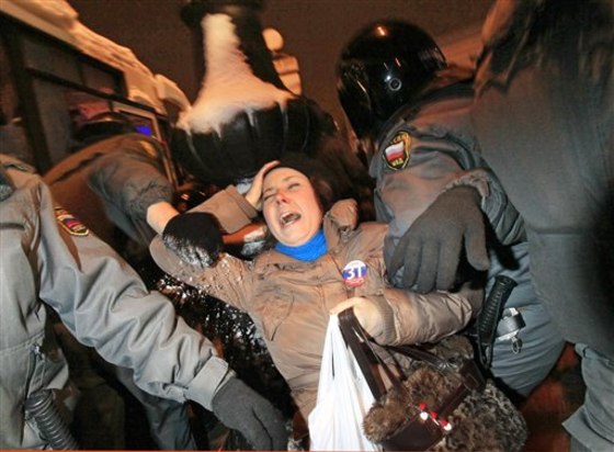 Police officers detain an opposition activist during a banned anti-Kremlin protest in St. Petersburg, Russia, on Monday. Opposition groups have been calling rallies on the 31st day of each month to honor the 31st article of the Russian Constitution, which guarantees the right of assembly. Most of the rallies have been banned or dispersed by police as unsanctioned.